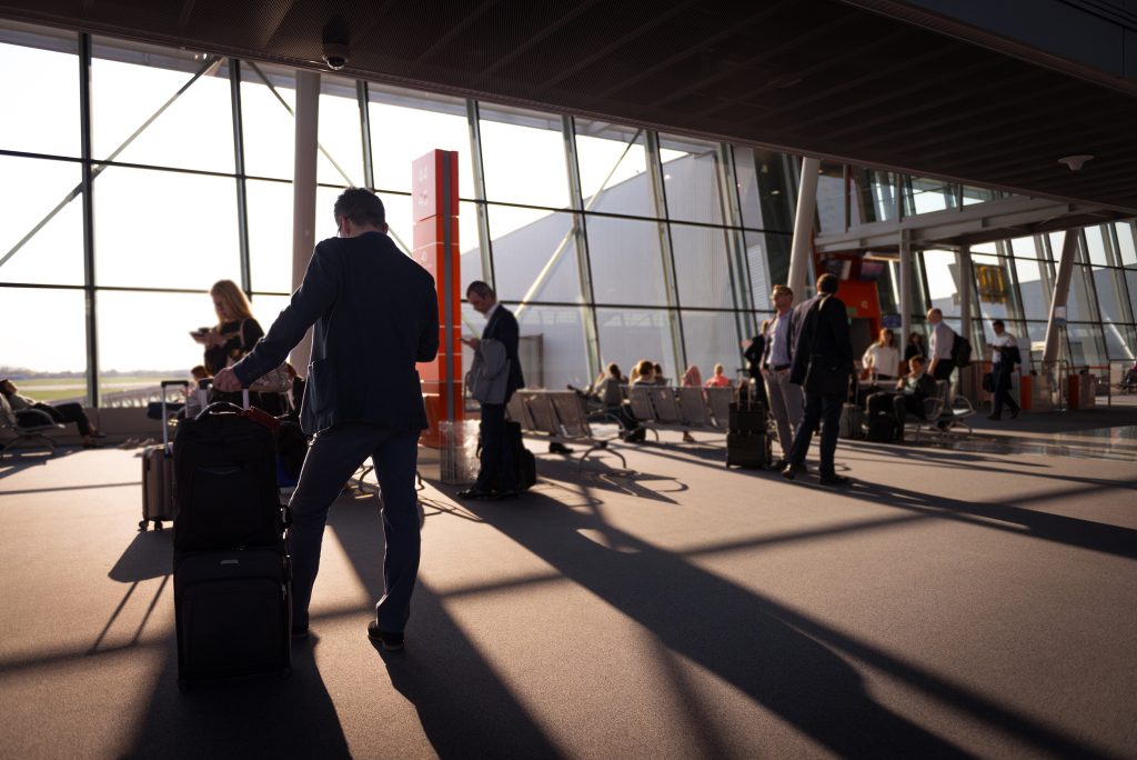 Business travelers waiting by an aiport gate